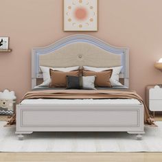 a bedroom with a bed, nightstands and pictures on the wall above it in pastel colors