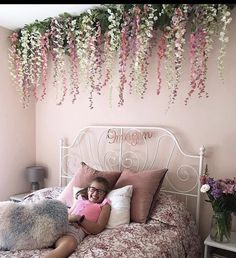 Faux Flower Wall Hanging, Bedroom Flower Ceiling, Bedroom Ceiling Flowers, Hanging Flower Bedroom, Flower Hanging From Ceiling Bedroom, Flower Vine Ceiling Bedroom, Wisteria Canopy Bedroom, Flowers On Headboard, Hanging Flowers Bedroom Aesthetic