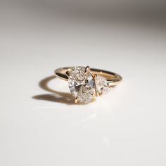 three stone diamond ring on white surface