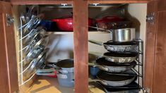 pots and pans are stacked in the bottom shelf of a kitchen cabinet with text overlay that reads organizing pots and pans