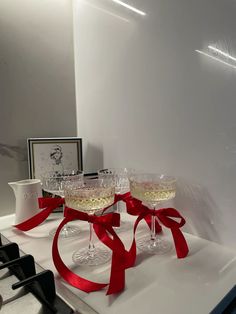 valentines day, champagne, cocktail glass, ribbon, bow, bows, glasses, glass, wine glass, champagne flute, drinks, luxury aesthetic, galentines, party, party planning, red Glasses With Ribbon Bows, Red Cocktail Aesthetic, Ribbon On Glasses, Luxury Valentines Day Aesthetic, Ribbon On Wine Glasses, Christmas Champagne Glasses, Bows On Glasses, Bows On Wine Glasses, Birthday Party Red Theme