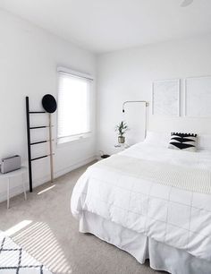 a bedroom with white walls and carpeted flooring