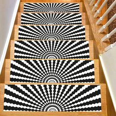 three black and white rugs are on the stairs