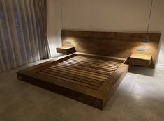 a bed with wooden headboard and foot board in a room next to a window