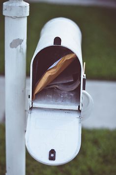 a mailbox with an envelope sticking out of it