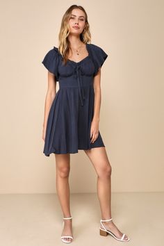 Let your precious side show off in the Lulus Adorable Personality Navy Blue Linen Off-the-Shoulder Mini Dress! This sweet dress has a lightweight, woven linen-blend fabrication that shapes a ruffle-trimmed, elasticized off-the-shoulder neckline that flows into fluttery short sleeves. Fitted bodice features seamed cups and a decorative tying detail at the center. High waist sits atop a skater skirt that finishes at a cute mini hem. Hidden side zipper. Fit: This garment fits true to size. Length: Cotton Off-shoulder Mini Dress For The Beach, Off-shoulder Cotton Mini Dress For Beach, Chic Blue Linen Mini Dress, Summer Off-shoulder Linen Dress, Casual Linen Mini Dress For Brunch, Chic Off-shoulder Linen Dress, Casual Linen Dress For Date Night, Knot Tie Dress, Side Show