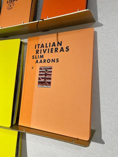 three books with italian riviera's and slim aarons written on them