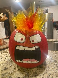 a pumpkin with an angry face painted on it