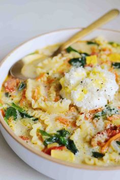 a white bowl filled with pasta and vegetables