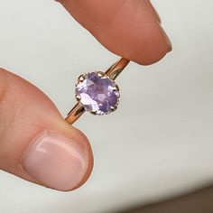 Combining timeless elegance with a touch of sea-inspired charm, our Scallop Cup Solitaire is a one-of-a-kind ring! It features a weighty, 14k recycled yellow gold band with a classic, rounded shank and polished finish. This specific Scallop Cup Solitaire features a beautiful, pastel purple oval sapphire from Sri Lanka. Center Stone Details: Gemstone: Sapphire Hardness: 9/10, great for everyday wear! Carat Weight: 1.97ct Shape + Cut: Modern Oval Brilliant/Roval Origin: Sri Lanka Dimensions: 8.47x Elegant Lavender Amethyst Ring In 14k Gold, Timeless Yellow Gold Amethyst Ring With Oval Shape, Elegant Lavender Solitaire Jewelry, Delicate Oval Solitaire Jewelry, Timeless Oval Amethyst Ring As Gift, Timeless Oval Amethyst Ring For Gift, Lavender 14k Gold Rings Fine Jewelry, 14k Gold Lavender Amethyst Ring, Timeless Oval Purple Jewelry