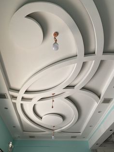 the ceiling in this room is decorated with circular shapes and lights hanging from it's sides