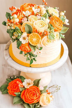 an orange and white cake with flowers on top