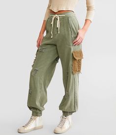 POL Pieced Cargo Pant - Green Medium, Women's Shadowgreen High rise pant Fraying crochet and destruction with fill yarn details Elasticized cinch tie waistband and cuffs Inseam measures 29 Rise measures 12. This quality denim is hand-finished for a unique look. It will wear like your favorite jeans, with each hole and tear continuing to destruct over time. You will love the comfort of this denim that has the look and feel of years of wear. . 100% Cotton. Machine wash cold on permanet press. Tumb Distressed Cotton Utility Bottoms, Casual Distressed Cargo Pants For Spring, Spring Distressed Casual Cargo Pants, Spring Casual Distressed Cargo Pants, Green Drawstring Bottoms For Fall, Fall Green Bottoms With Drawstring, High Rise Pants, Sand Beige, Cargo Pants Women