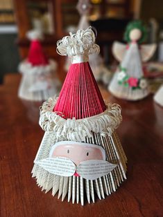 an ornament made out of book pages sitting on top of a wooden table