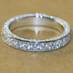 a close up view of a wedding ring with diamonds on the inside and outside of it