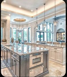 a large kitchen with marble counter tops and an island in front of the stove top