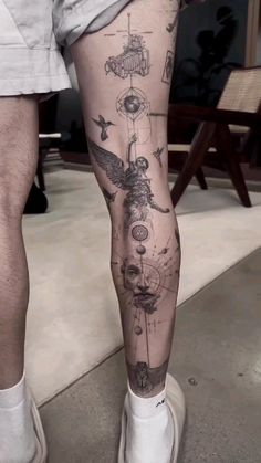 a man's leg with tattoos on it and his legs are covered in drawings