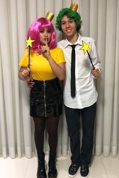 two people dressed up in costumes posing for a photo with wands and stars on their heads