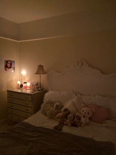 a bedroom with teddy bears on the bed and candles in the corner, next to a dresser