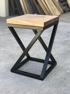 a small wooden table sitting on top of a carpeted floor