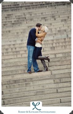 a man and woman kissing on the steps