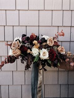 a bouquet of flowers in front of a brick wall