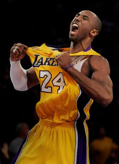 a basketball player is holding his jersey open and yawning while standing in front of the crowd