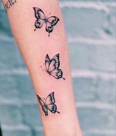 three butterflies tattoo on the arm