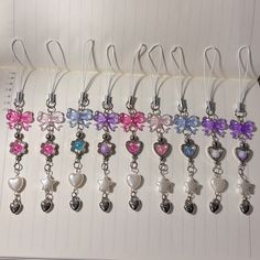 a bunch of heart shaped charms are hanging on a hook - up bookmarks