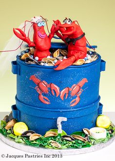 there is a cake made to look like a bucket with lobsters in it