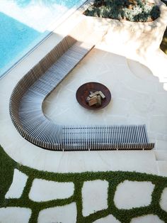 an outdoor swimming pool with grass on the ground