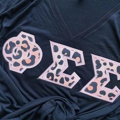 a t - shirt with the word boo spelled out in leopard print on it's chest