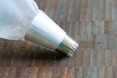 a close up of a plastic bag on a wooden floor with a pen in it