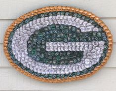 the green bay packers logo is made out of glass beads on a white house wall