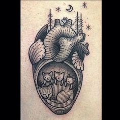 a heart tattoo with cats inside it