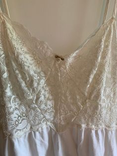 Gorgeous lace bodice short nightgown. Victoria's Secret vintage label tagged size small.  Lace bodice has a bit of stretch and is ecru/off-white in color.  Rosette decoration at front bust.  Bottom half of gown is cotton knit and is cream/off-white in color.  Straps are adjustable.  Very clean. 100% cotton.  Vintage item.   Bust flat unstretched is 14 inches and stretches to 17-18 inches.  Length is 32-33 inches as shown. Straps adjust.  Please check measurements with something you own that is s Cream Lace Wedding Nightgown, Wedding Cream Lace Nightgown, Lace Trim Camisole For Daywear, Lace Camisole With Lace Trim For Daywear, Lace V-neck Nightgown With Lace Trim, Feminine White Camisole With Lace Patchwork, White Feminine Camisole With Lace Patchwork, Feminine Cream Nightgown With Lace Trim, White Lace Camisole With Contrast Lace