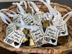 a wicker basket filled with lots of bottles of wine and tags attached to them