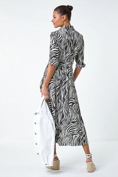 Zebra Print Midi Shirt Dress from Roman. Take a walk on the wild side with this animal print shirt dress. Cut from a smooth woven fabric this dress features a smart collared neckline and a fully open front complete with sweet button fastenings. Relaxed 3/4 sleeves are finished with smart shirt cuffs, while a self-tie fabric belt creates shape at the waist. Pair with chunky boots and a leather jacket for a chic but edgey smart casual look! Animal Print Shirt Dress, Animal Print Shirt, Print Shirt Dress, Zebra Dress, Walk On The Wild Side, Oasis Fashion, Shirt Cuff, Take A Walk, Midi Shirt Dress