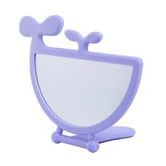 a purple mirror sitting on top of a wooden stand