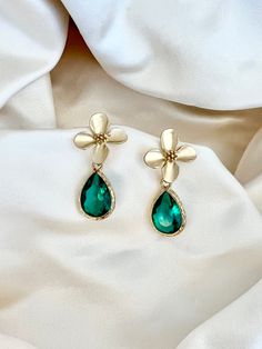 Enhance your elegance with our Green Teardrop Flower Earrings. These dainty and graceful accessories bring a touch of nature's beauty to your ensemble. Delicate gold flowers and a green crystal teardrop make them perfect for any occasion, from casual gatherings to special events. Handcrafted with care, these earrings are a delightful addition to your jewelry collection, offering a unique blend of charm and sophistication." * Crystals Gold flower earrings, green bridesmaid earrings, teardrop earrings, boho bridal earrings, whimsical earrings, woodland wedding, wedding gift Elegant Teardrop Earrings With Flower Charm, Green Flower Charm Drop Earrings, Elegant Green Earrings With Flower Charm, Teardrop Flower Charm Jewelry For Wedding, Green Flower Shaped Jewelry For Wedding, Delicate Green Flower Earrings For Wedding, Elegant Green Flower Earrings, Teardrop Wedding Jewelry With Flower Charm, Green Flower Shaped Wedding Jewelry