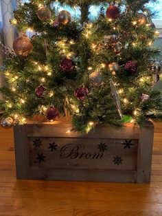 a small christmas tree in a wooden crate