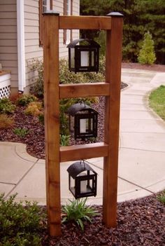 a wooden ladder with three lanterns on it