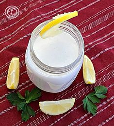 coconut buttermilk in a jar with lemon wedges and parsley around it