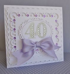 a white card with a purple bow and the number forty