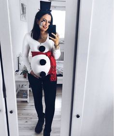 a woman is taking a selfie with her cell phone wearing a snowman costume