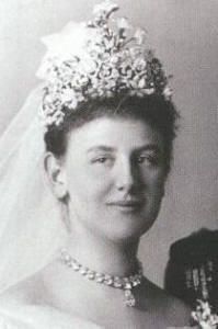 an old black and white photo of a woman in a wedding dress wearing a tiara