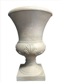 a large white vase sitting on top of a table