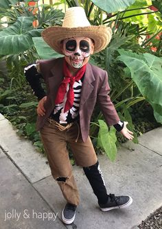 a man in a skeleton costume is posing for the camera with his arms out and hat on