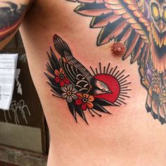 a close up of a person's stomach with tattoos on it and an owl