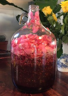 a vase filled with flowers on top of a wooden table